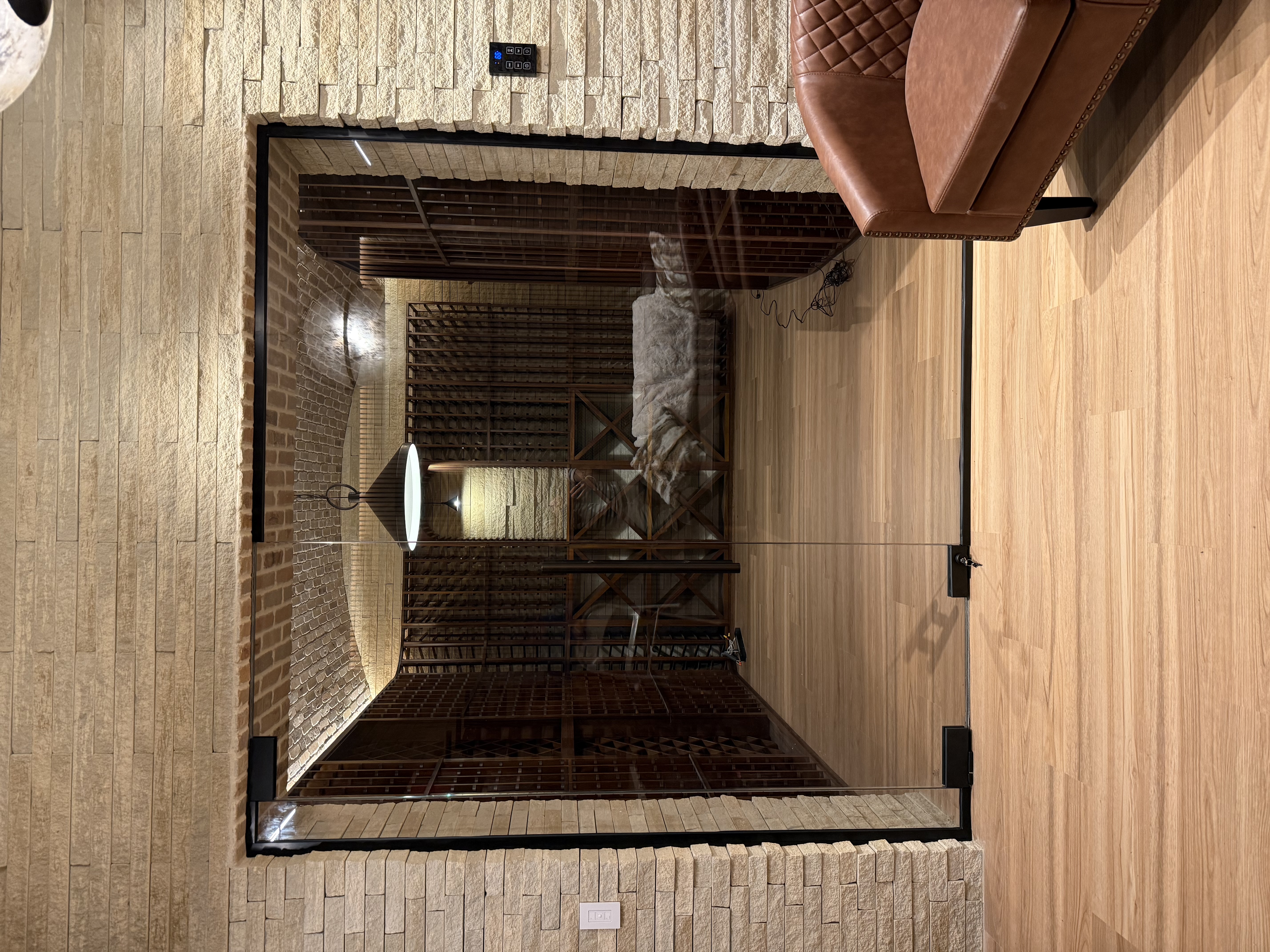 This wine room includes a lock on the bottom hinge for safe keeping!