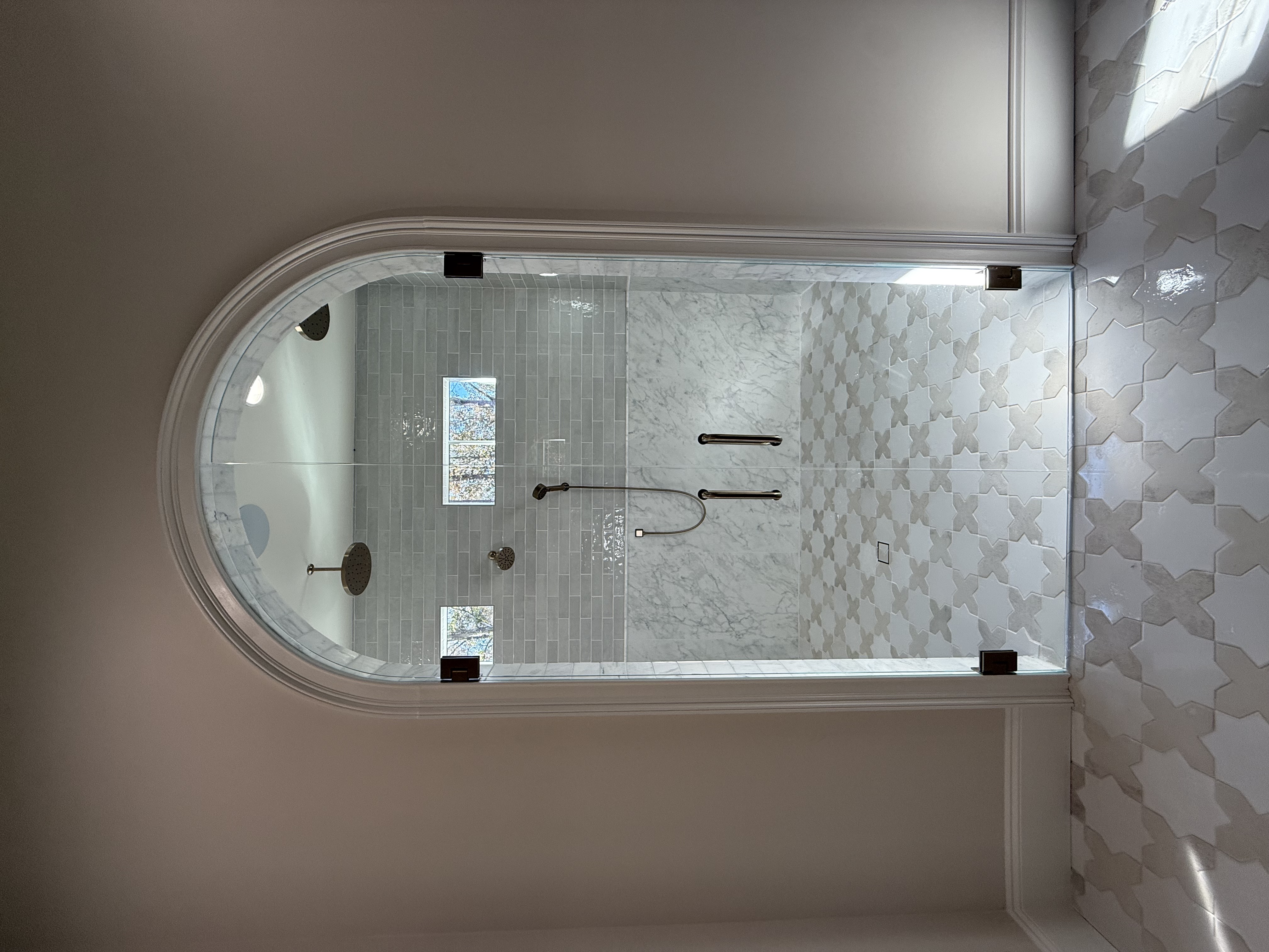 These are arched French doors for a gorgeous shower room by Southern Pines Renovations.